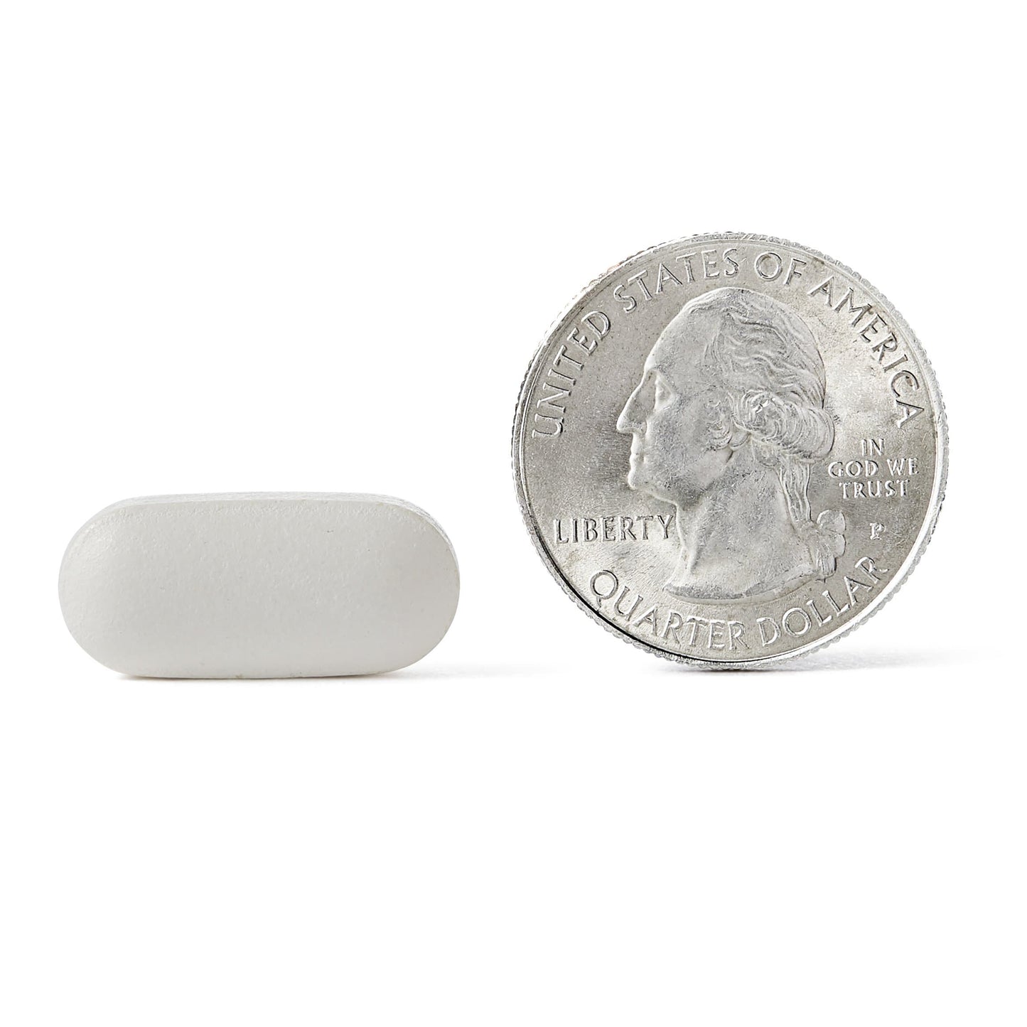 Move-Free pill beside a quarter coin